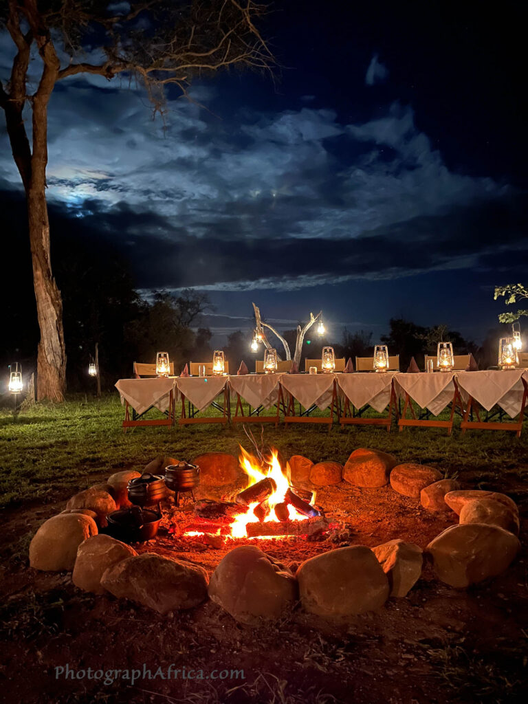 Dining around the fire while on safari